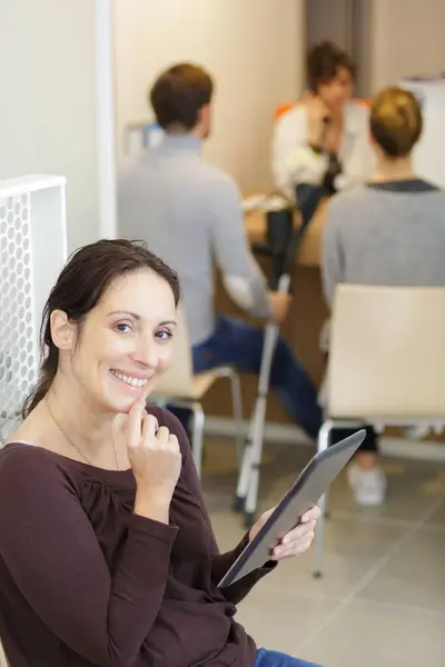 Woman Using Tablet While Waiting Maedical Appointment — Stock Photo, Image