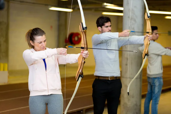 Couple Practicing Archery Indoors — Stock Photo, Image