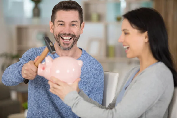 Cheerful Couple Poised Smash Piggy Bank — Stock Photo, Image