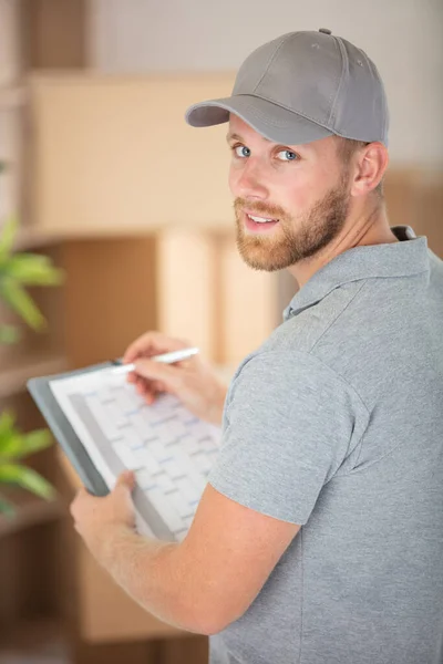 Young Male Worker Standing Cardboard Box Holding Clipboard — Stock Photo, Image