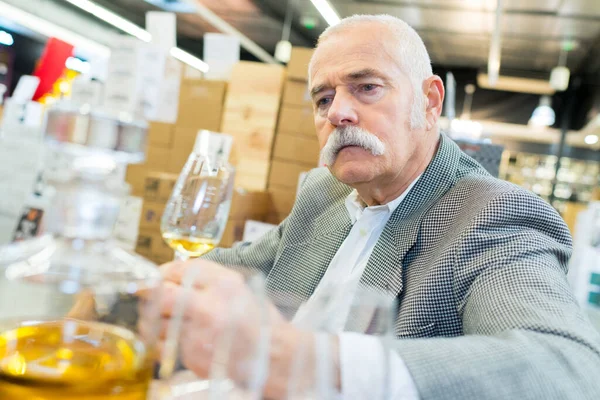 Senior Man Provtagning Glas Konjak — Stockfoto