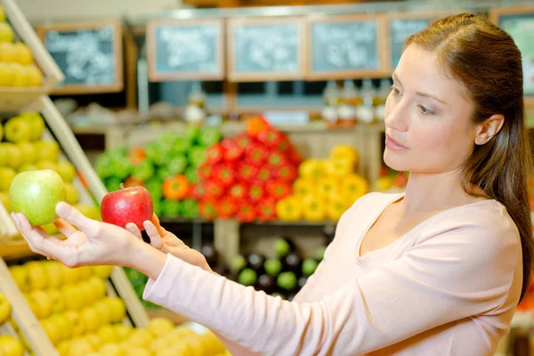 Woman Comparing Apples — Stock Photo, Image