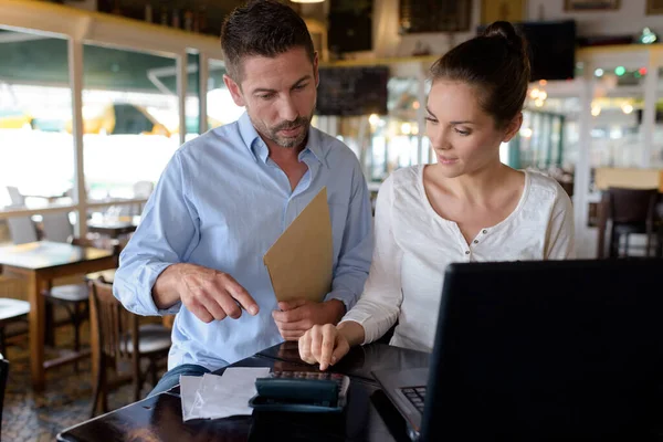 stock image confident restaurant manager assisting new employee