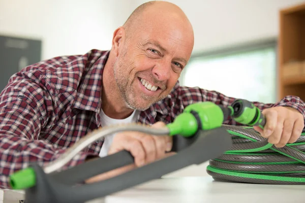 a happy gardener during hose connection