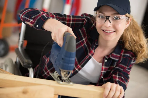 Positive Woman Cutting Wood — Stock Photo, Image