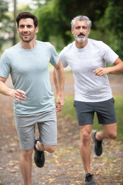 Two Sportsmen Running Outdoors — Stock Photo, Image