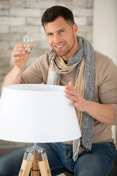 Asian Man Changing Light Bulb — Stock Photo, Image