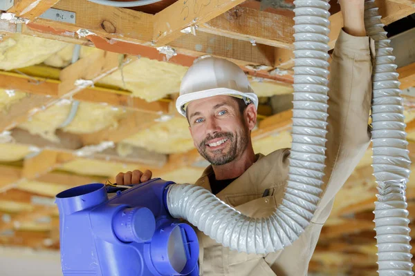 Happy Worker Holding Pipe Incomplete Wooden Cabin — Stock Photo, Image