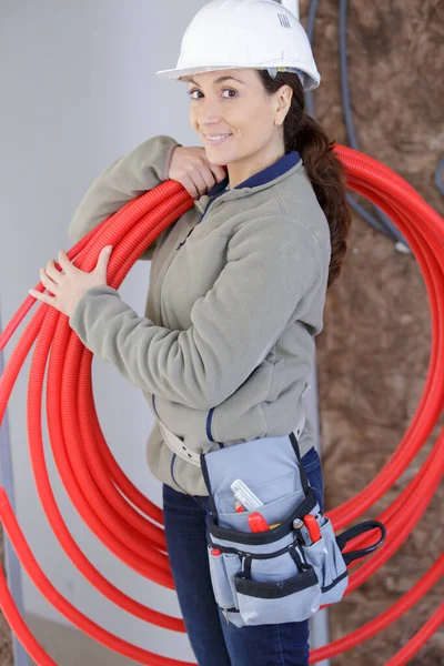 Female Builder Holding Pipes — Stock Photo, Image