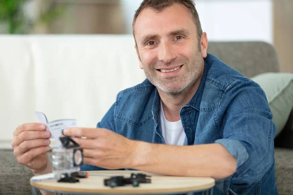 Man Unboxing His New Camera Reading Manual — Stock Photo, Image