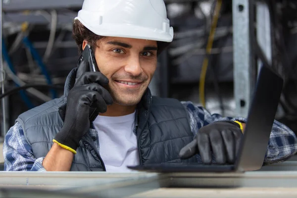 Young Electrician Holding Mobile Phone While Working — Stock Photo, Image