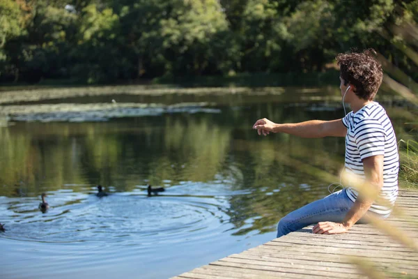 Junger Mann Füttert Enten Teich — Stockfoto
