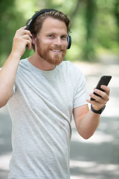 Handsome Young Sportsman Outdoors Park Listening Music Earphones — Stock Photo, Image