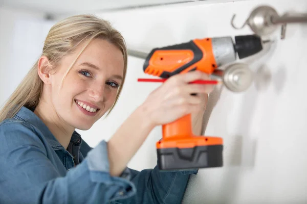 Woman Securing Curtain Rail Using Cordless Drill — Stock Photo, Image