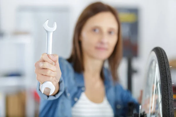 Female Bicycle Mechanic Showing Spanner — Stock Photo, Image