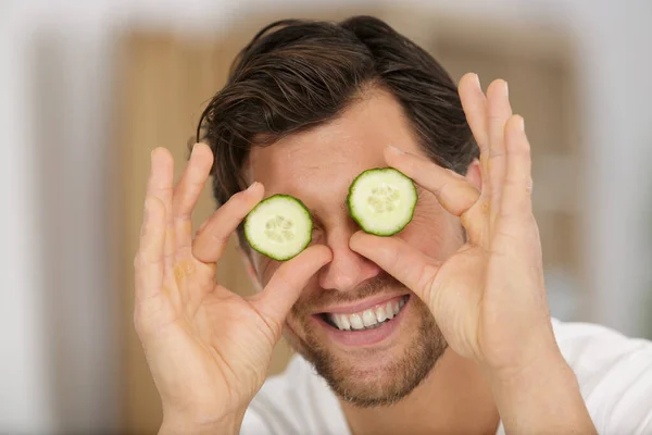 Playful Man Holding Slices Cucumber His Eyes — Stock Photo, Image