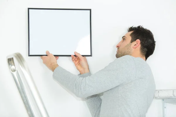 Man Positioning Picture Frame Wall — Stock Photo, Image