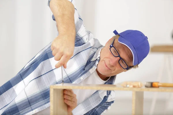 Mature Man Screwing Screws Furniture Fittings — Fotografia de Stock