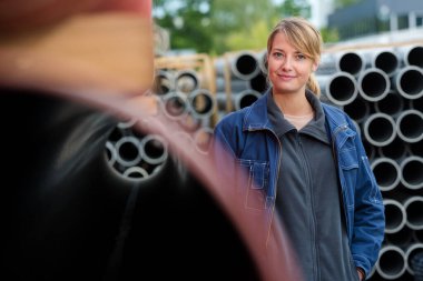 portrait of female worker in building materials yard clipart