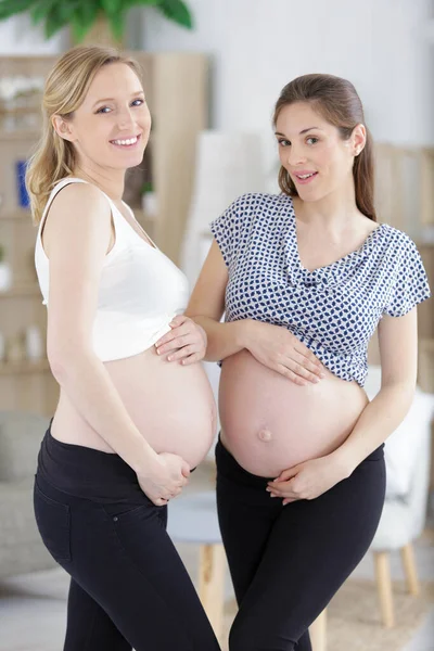 Two Pregnant Girlfriends Showing Bellies — Stock Photo, Image
