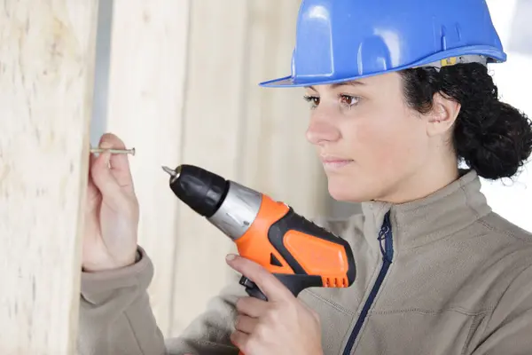 Female Builder Using Cordless Screwdiver Insert Screw Wall — Stock Photo, Image