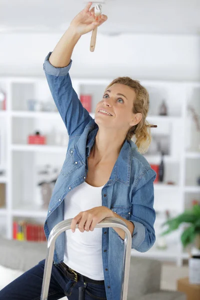 Blonde Woman Painting Ceiling — Stock Photo, Image