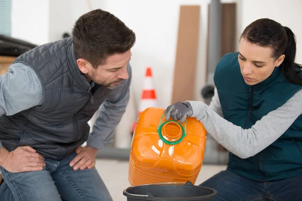 Young Caucasian Woman Fills Bucket Oil — Stock Photo, Image