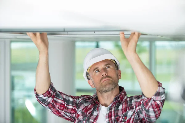 Construction Worker Changing Ceiling Panel Site — Stock Photo, Image