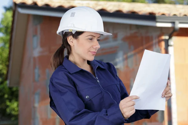 Woman Overalls Property Reading Paperwork — Stock Photo, Image