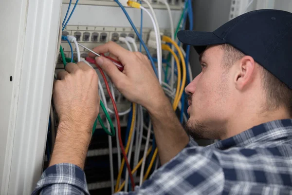 technician checking cables in a server