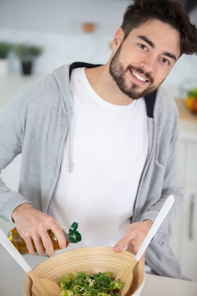 Young Man Making Fresh Salad — Stock Photo, Image