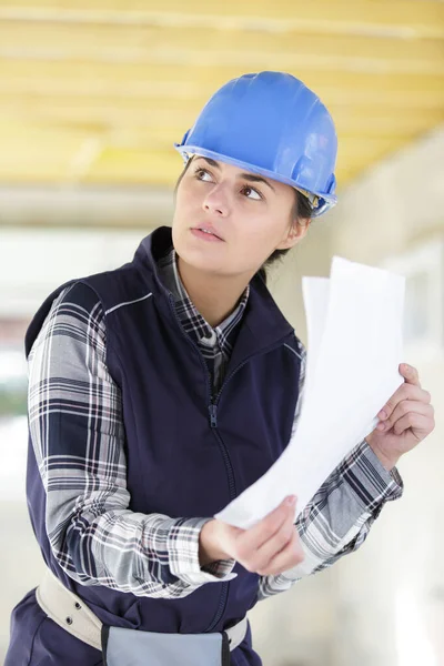 female architect wearing helmet during building construction