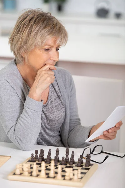 Пожилая Женщина Учится Играть Шахматы — стоковое фото