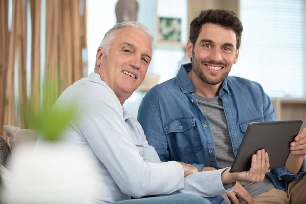 Pleasant Young Man Showing Tablet His Elderly Father — Stock Photo, Image