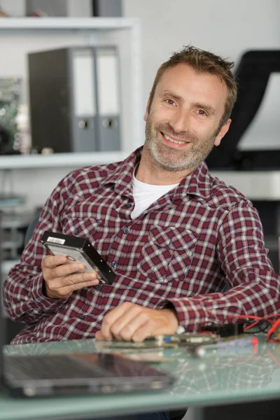 computer repairman holding a hardware component