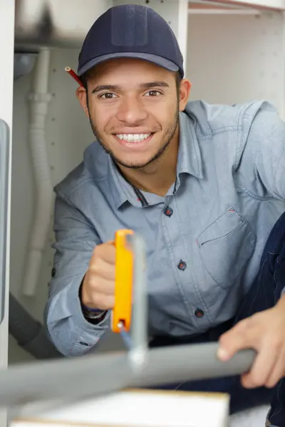 Young Male Plumber Sawing Pvc Pipe — Stockfoto