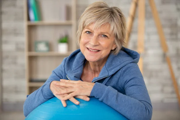 senior woman with fitness ball in gym