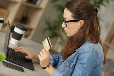 close up of female hands making online payment clipart