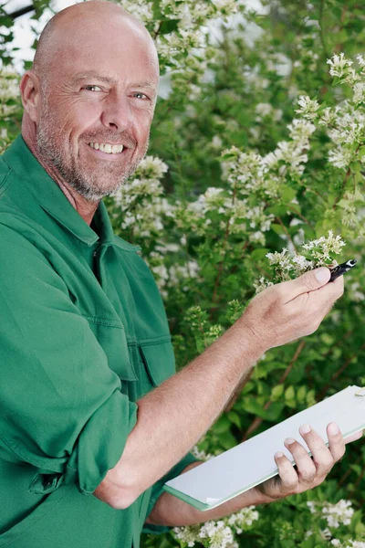 happy gardener holding clipboard