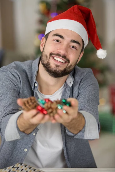 Festive Man Holding Handful Christmas Decorations — Stock Photo, Image