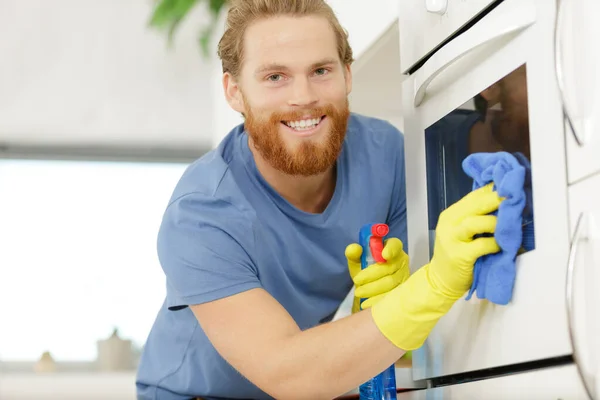 Happy Young Man Overall Cleaning Oven — Stock Photo, Image