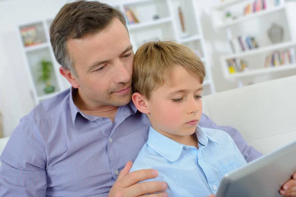 Father Cuddling Boy Looking Computer — Stock Photo, Image