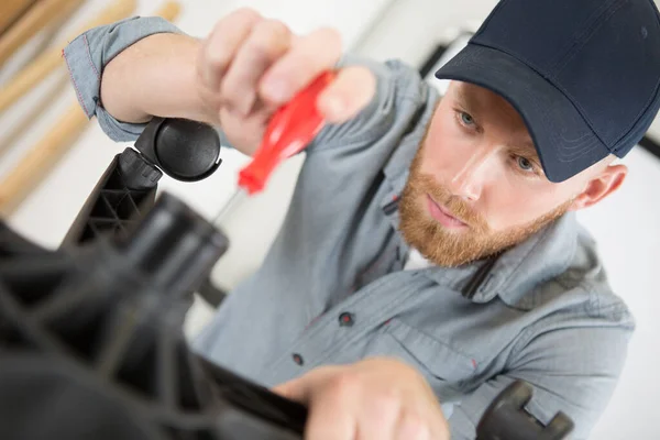 Man Fixing Office Chair — Stock Photo, Image