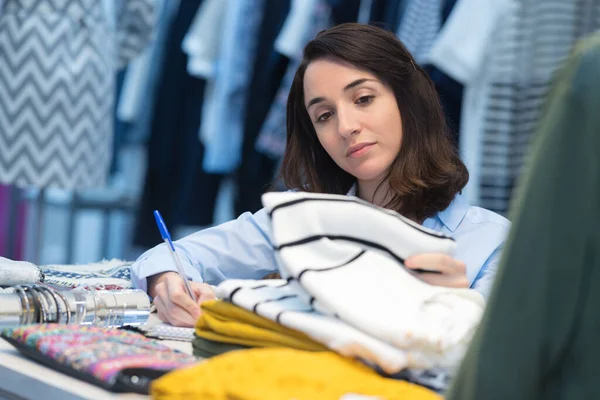 woman working at her fashion store