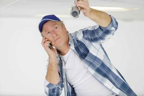 Mature Man Tuning Cctv Camera Stock Picture