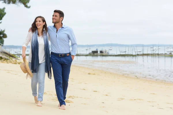 couple walking along the sea shore