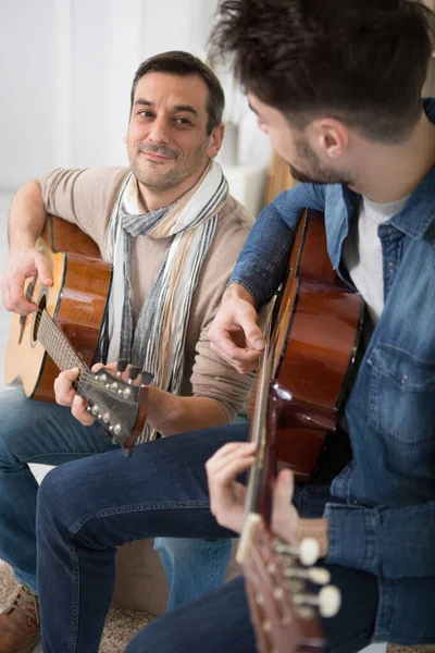 Father Small Son Sitting Sofa Indoors Playing Guitar — Stock Photo, Image