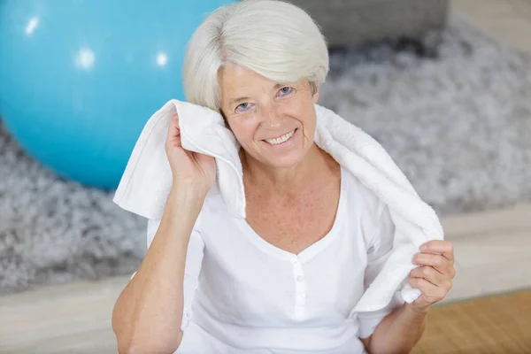 senior woman using a towel after sport