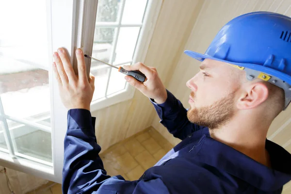 Young Male Contractor Using Screwdriver Window Catch — Stock Photo, Image