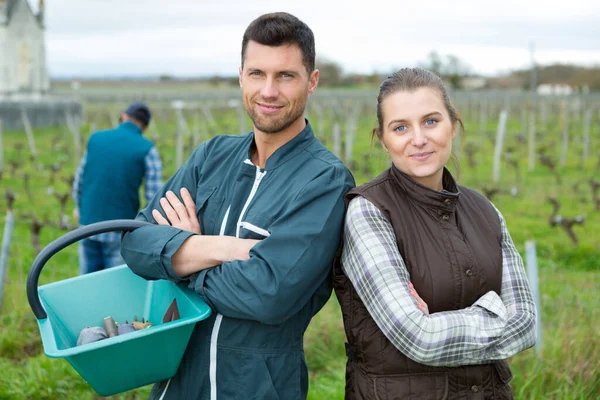 cheerful young farmers couple in vineyard